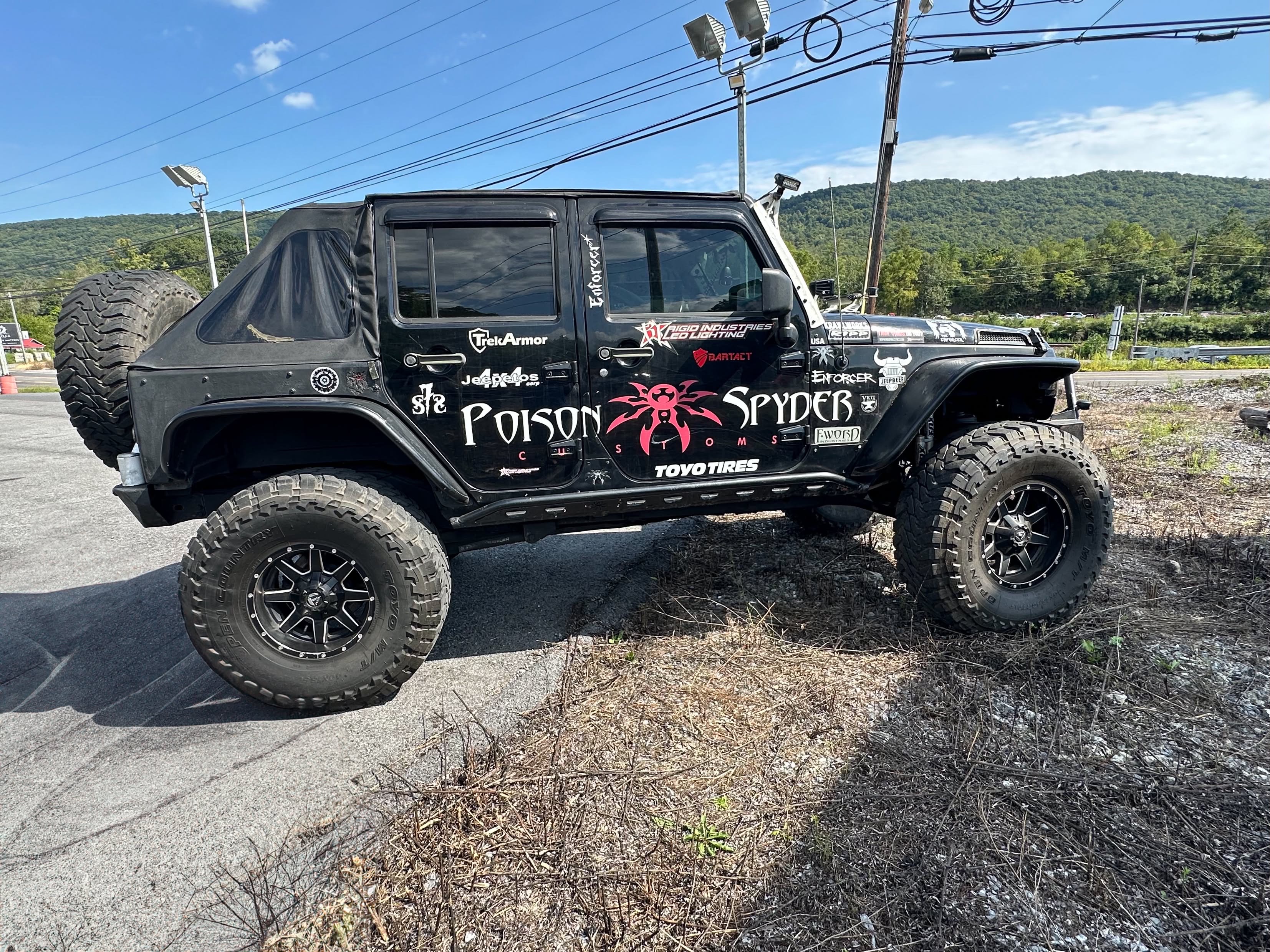 Jeep Wrangler JK front end with Warn winch mounted to the Poison Spyder Brawler bumper