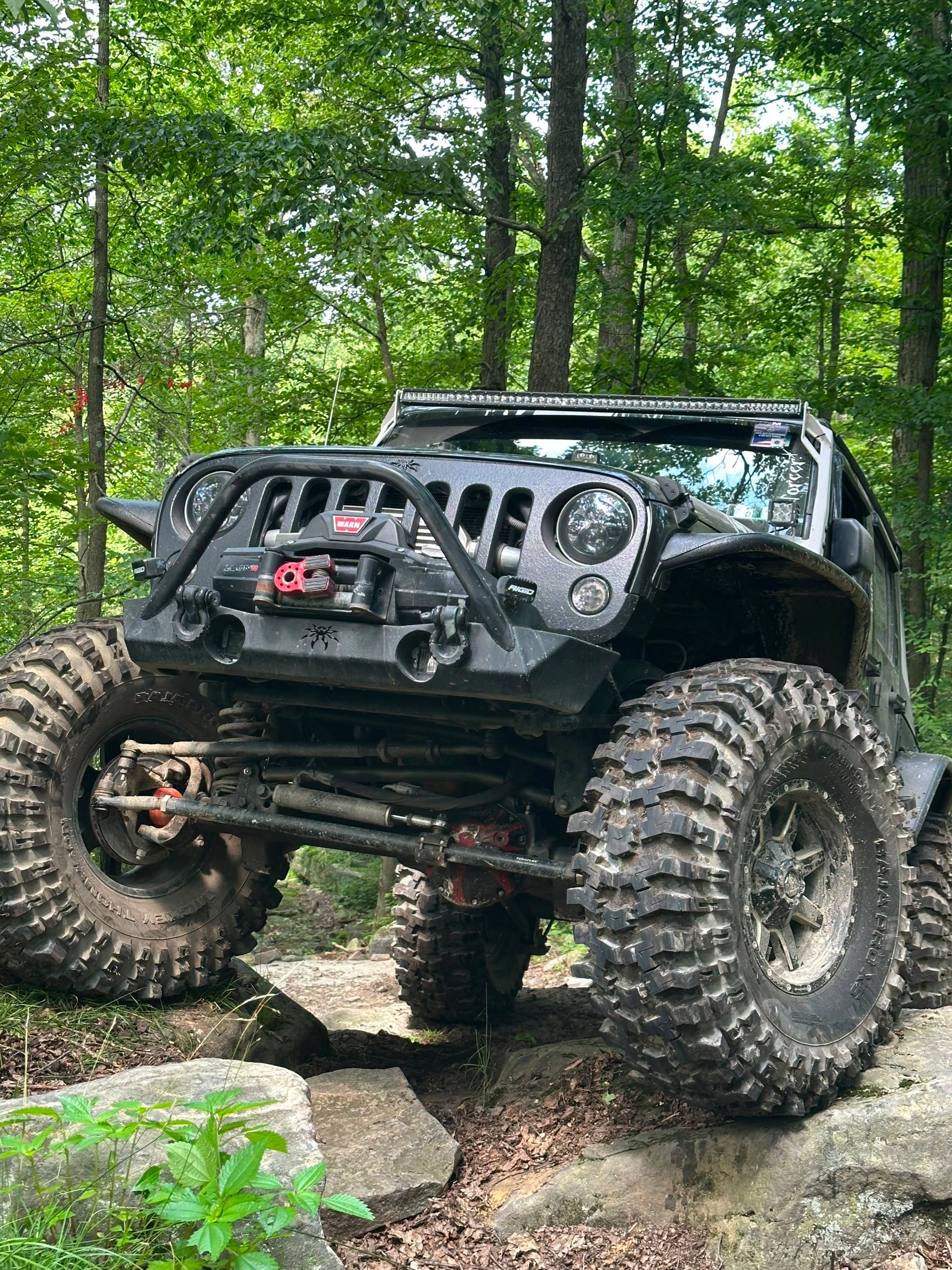 Enforcer, a 2007 Jeep Wrangler JK Sahara with Poison Spyder Brawler armor, on the trail